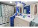 Charming bathroom with vibrant blue tile, seashell shower curtain, and ample counter space at 806 Conway St. # 116, North Myrtle Beach, SC 29582