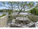 Charming outdoor deck with a weathered picnic table, overlooking the serene water and lush green trees at 806 Conway St. # 116, North Myrtle Beach, SC 29582