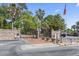Elegant gated entrance with brick pillars, palm trees, and an American flag at 806 Conway St. # 116, North Myrtle Beach, SC 29582