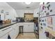 Compact kitchen featuring white cabinetry, tile countertops, and essential appliances for easy meal prep at 806 Conway St. # 116, North Myrtle Beach, SC 29582