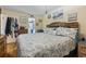 Bright bedroom with beach themed artwork, wood floors, and a view into the en-suite bathroom at 806 Conway St. # 116, North Myrtle Beach, SC 29582