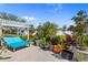 Landscaped backyard patio featuring a pergola with blue outdoor seating and potted plants at 808 Atlantic Commons Dr., Surfside Beach, SC 29575
