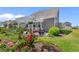 Charming backyard patio with a pergola, surrounded by lush landscaping and colorful roses at 808 Atlantic Commons Dr., Surfside Beach, SC 29575