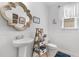 Quaint bathroom with pedestal sink, charming mirror, and cottage style furnishings at 808 Atlantic Commons Dr., Surfside Beach, SC 29575