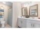 Bright bathroom with double vanity sinks and a shower featuring patterned curtain at 808 Atlantic Commons Dr., Surfside Beach, SC 29575