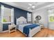 Comfortable bedroom with a white bed frame, blue accents, and natural light at 808 Atlantic Commons Dr., Surfside Beach, SC 29575