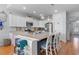Stylish kitchen with an island, white cabinets, stainless appliances, and bar seating at 808 Atlantic Commons Dr., Surfside Beach, SC 29575