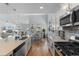 Open-concept kitchen with white cabinets, stainless appliances, island, and sightlines into an adjacent living area at 808 Atlantic Commons Dr., Surfside Beach, SC 29575