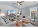 Bright living room features shiplap walls, ceiling fan and comfortable seating at 808 Atlantic Commons Dr., Surfside Beach, SC 29575