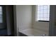 Bright bathroom featuring a large soaking tub and a window for natural light at 843 Brookline Dr., Myrtle Beach, SC 29579