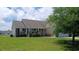 Quaint single-story home with lush landscaping and a cozy front porch, perfect for relaxing outdoors at 843 Brookline Dr., Myrtle Beach, SC 29579