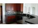 Kitchen with a bar area featuring dark cabinets and a stainless steel sink at 843 Brookline Dr., Myrtle Beach, SC 29579