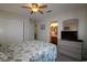 Bedroom with ceiling fan, closet, dresser with television, and bathroom view at 861 Tall Oaks Ct. # D-61, Myrtle Beach, SC 29588