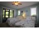 Bedroom with two twin beds, sliding glass door to porch, and ceiling fan at 861 Tall Oaks Ct. # D-61, Myrtle Beach, SC 29588