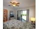 Bedroom featuring a ceiling fan, sliding glass door to backyard, and view of bathroom at 861 Tall Oaks Ct. # D-61, Myrtle Beach, SC 29588
