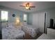 Bedroom with two twin beds, ceiling fan, closet, and side table with a lamp at 861 Tall Oaks Ct. # D-61, Myrtle Beach, SC 29588