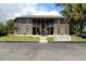 Two-story exterior of the property with stairs and a well-maintained lawn with a palm tree in the distance at 861 Tall Oaks Ct. # D-61, Myrtle Beach, SC 29588