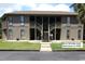 Inviting condo with two-story facade, accessed by a central staircase and featuring wood-look siding and verdant lawn at 861 Tall Oaks Ct. # D-61, Myrtle Beach, SC 29588
