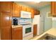 Bright kitchen features wooden cabinets, white appliances, and lots of countertop space at 861 Tall Oaks Ct. # D-61, Myrtle Beach, SC 29588