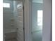 Bathroom with tile flooring and walls and white door at 8719 Baton Rouge Ave Nw, Calabash, NC 28467