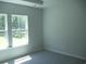 Bedroom featuring plush carpet, large windows and neutral paint at 8719 Baton Rouge Ave Nw, Calabash, NC 28467