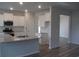 Bright kitchen featuring granite countertops, white cabinets and stainless steel appliances at 8719 Baton Rouge Ave Nw, Calabash, NC 28467