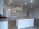 Bright kitchen featuring granite countertops, white cabinets and stainless steel faucet fixture at 8719 Baton Rouge Ave Nw, Calabash, NC 28467