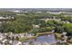 An aerial view showcasing the neighborhood homes surrounded by lush trees and a beautiful lake at 886 Carolina Farms Blvd., Myrtle Beach, SC 29579