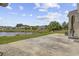 Spacious backyard with a lake view, a concrete patio, and lush green grass at 886 Carolina Farms Blvd., Myrtle Beach, SC 29579