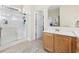 Bathroom with a walk-in shower, vanity with storage, tile floor, and a view into an adjoining bedroom at 886 Carolina Farms Blvd., Myrtle Beach, SC 29579