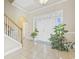 Welcoming foyer with tile flooring, staircase and double doors with plants at 886 Carolina Farms Blvd., Myrtle Beach, SC 29579