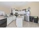 Well-lit kitchen features stainless steel appliances, center island, tile floors and plenty of cabinet space at 886 Carolina Farms Blvd., Myrtle Beach, SC 29579