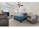Main bedroom features a tray ceiling, a ceiling fan, and a cozy sitting area at 886 Carolina Farms Blvd., Myrtle Beach, SC 29579