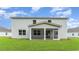 Rear view of the home showcasing the screened porch and a spacious backyard with lush green lawn at 889 Ireland Dr., Longs, SC 29568