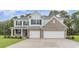 Charming two-story home featuring a brick facade, attached two-car garage, and manicured lawn at 889 Ireland Dr., Longs, SC 29568