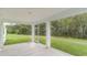 The screened porch provides a serene view of a lush, green backyard filled with mature trees and peaceful surroundings at 889 Ireland Dr., Longs, SC 29568