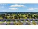 Aerial view of homes in a golf course community and wooded views at 9169 Nw Oldfield Rd., Calabash, NC 28467