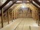 Unfinished attic space is framed with wood beams and plywood siding at 9169 Nw Oldfield Rd., Calabash, NC 28467