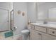 Bathroom features white vanity with framed mirror and shower with glass enclosure and marble tile at 9169 Nw Oldfield Rd., Calabash, NC 28467