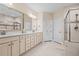 Expansive bathroom features dual vanities, framed mirrors, and a large shower with glass enclosure at 9169 Nw Oldfield Rd., Calabash, NC 28467