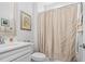 Cozy bathroom featuring a shower with a patterned curtain, a modern sink, and neutral décor at 9169 Nw Oldfield Rd., Calabash, NC 28467