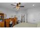 Well-organized bedroom featuring a vintage roll top desk, bookcase and fan for comfortable living at 9169 Nw Oldfield Rd., Calabash, NC 28467