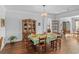 Formal dining room featuring elegant china cabinet, hardwood floors and a modern chandelier at 9169 Nw Oldfield Rd., Calabash, NC 28467