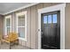Cozy covered front porch featuring an exterior window and a wooden bench for relaxed outdoor seating at 9169 Nw Oldfield Rd., Calabash, NC 28467