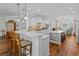 Expansive kitchen with an island, bar seating, stainless steel appliances, and white cabinetry at 9169 Nw Oldfield Rd., Calabash, NC 28467