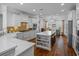 Bright, open kitchen with white cabinets, stainless appliances, and a central island with seating at 9169 Nw Oldfield Rd., Calabash, NC 28467