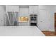 Modern kitchen with stainless steel appliances, white cabinets and a large countertop island at 9169 Nw Oldfield Rd., Calabash, NC 28467