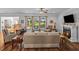 Inviting living room featuring a cozy fireplace, ceiling fan, and picturesque views of the lush golf course at 9169 Nw Oldfield Rd., Calabash, NC 28467
