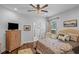 Inviting bedroom with patterned bedding, a TV, and an ensuite bathroom creating a private retreat at 9169 Nw Oldfield Rd., Calabash, NC 28467