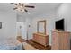 Bright bedroom features hardwood floors, a mounted TV, and ample space for relaxation and entertainment at 9169 Nw Oldfield Rd., Calabash, NC 28467